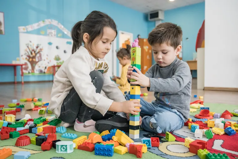 Children playing in a classroom.
