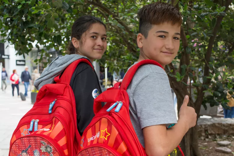 Two 11 year-old children from Afghanistan head to school in Greece