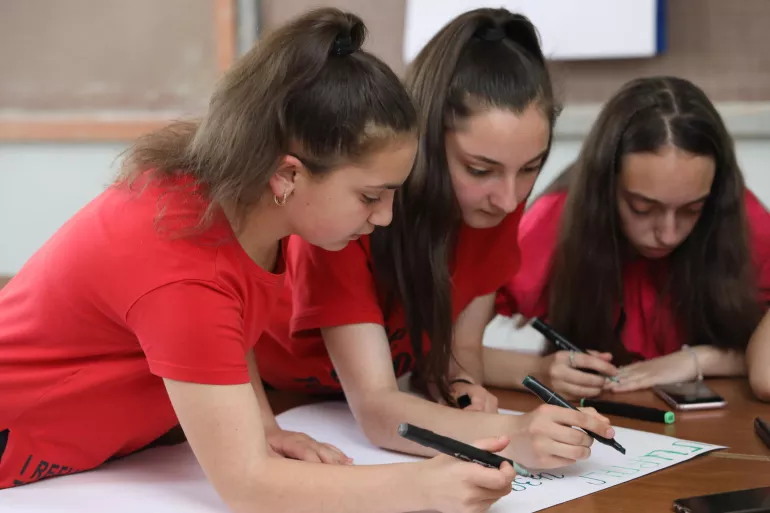 Three young girls working on their project on climate change