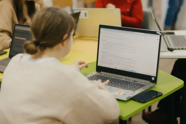 A girl types on a computer