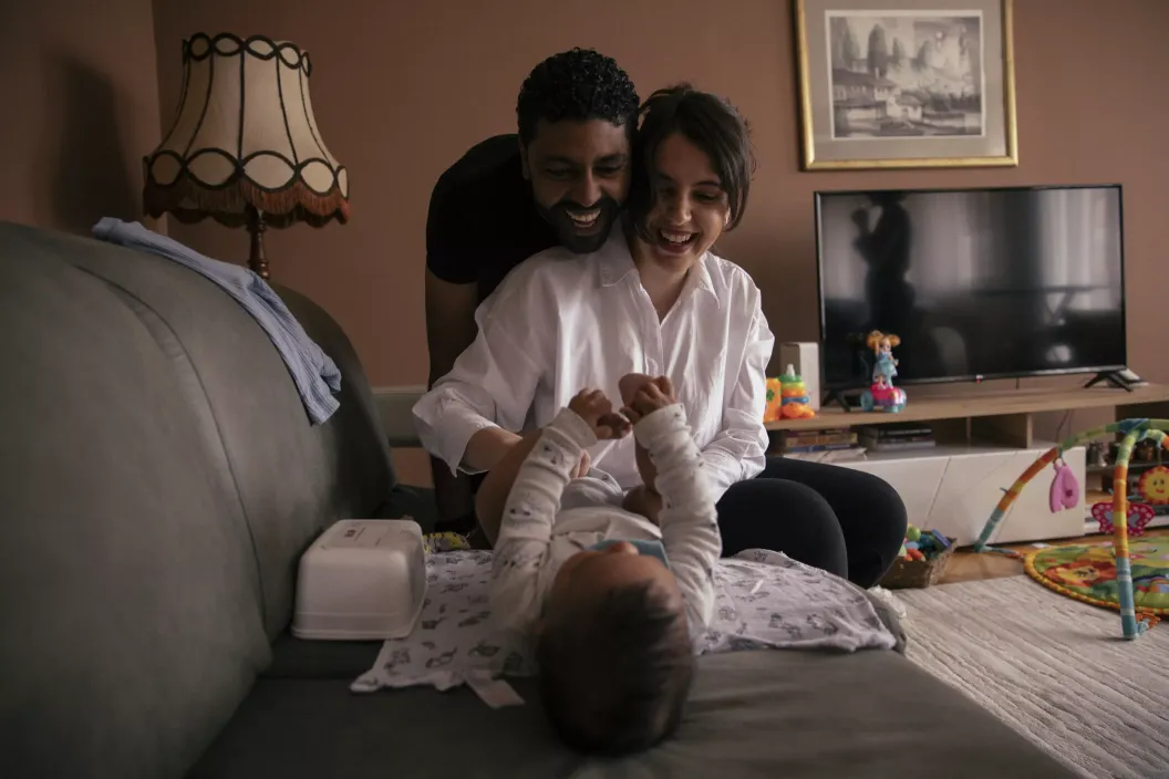 Parents play with their child. 