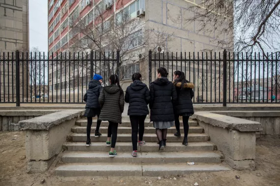 Aliya, 13, walks with her classmates in Aktau, Kazakhstan.  Aliya is a survivor of domestic violence and receives support  from a UNICEF-backed crisis centre to help her and her  siblings overcome their distress and trauma. March 2018. 