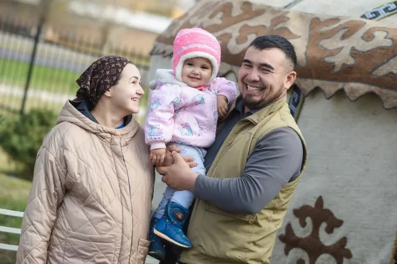 Three-year-old Altynai and her parents Jyldyz and Asylbek have found the new early childhood education center very beneficial. "Before, we didn't know how to teach her," Jyldyz says. 