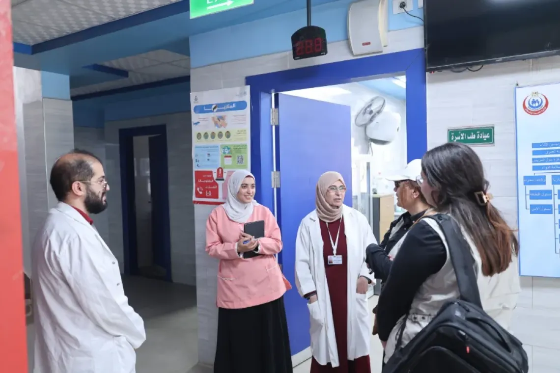 Healthcare workers havig a conversation with parents