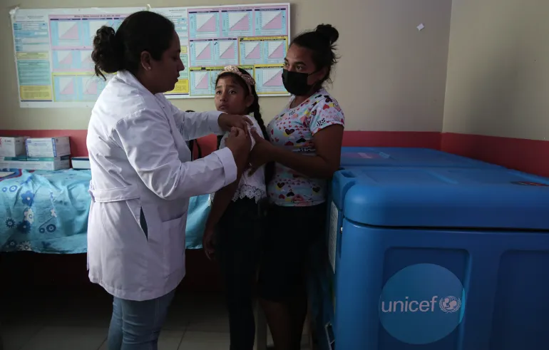 Dr. Maryuri Sevilla, director of the San Pedro health center, administers a COVID-19 vaccine to a girl at the health center to complete her vaccination schedule, in the city of S&eacute;baco, Matagalpa department.