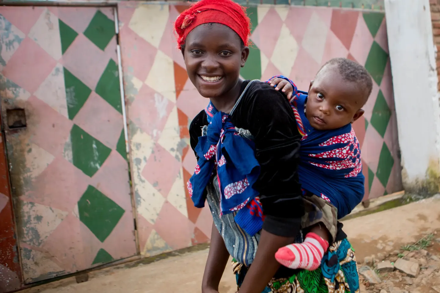 A young mother carrying her baby
