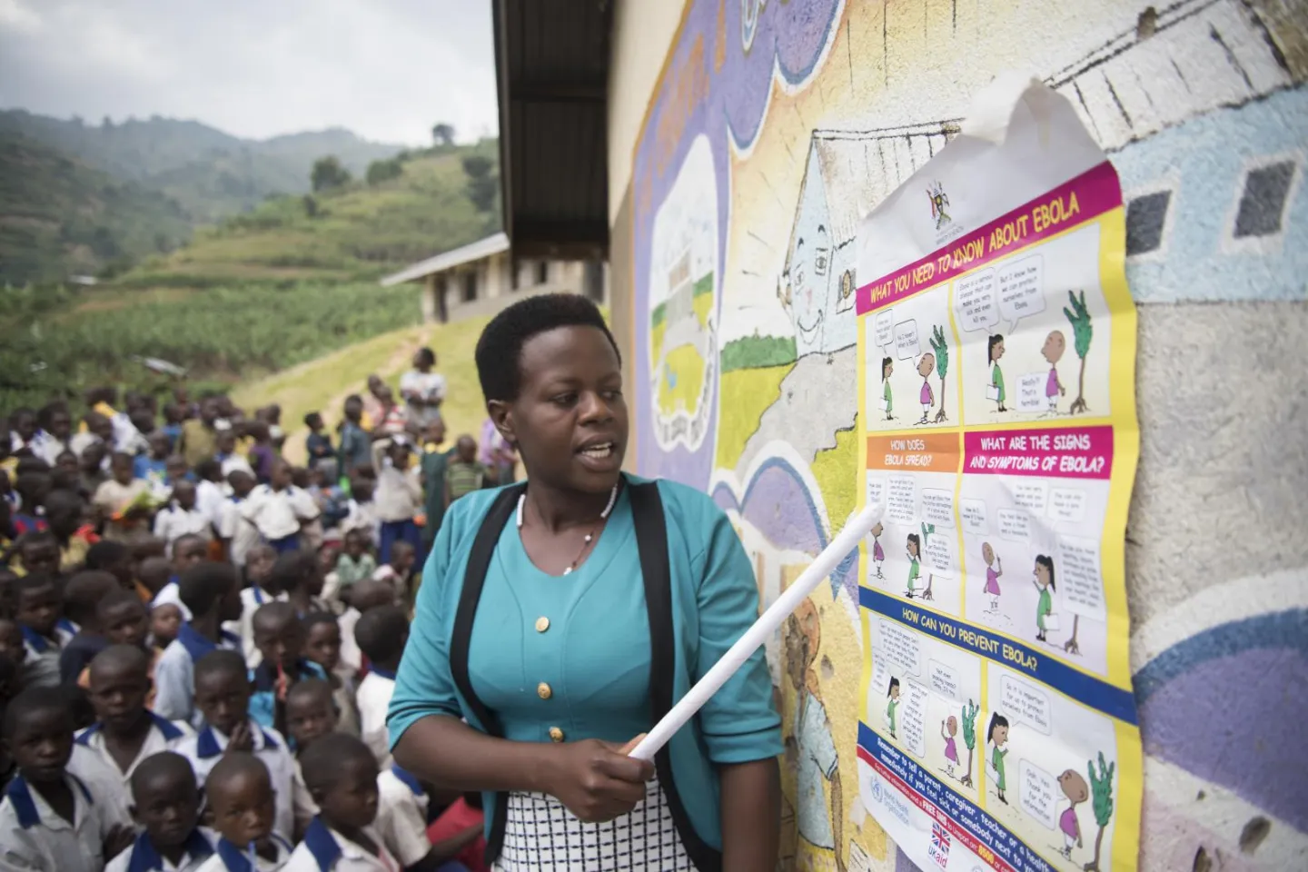 A woman points to a poster on Ebola
