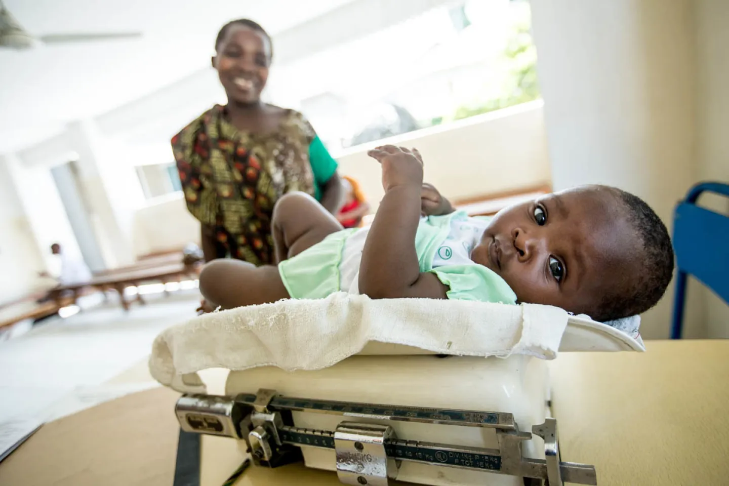 Tecla, 6 months, is weighed at a routine health care visit. Her mother, Bertha, is living with HIV, but was able to prevent transmission of the virus to her daughter.