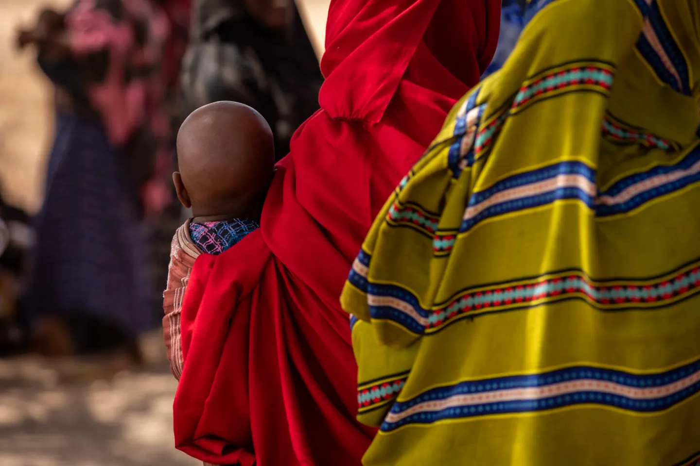 A child is carried by a woman