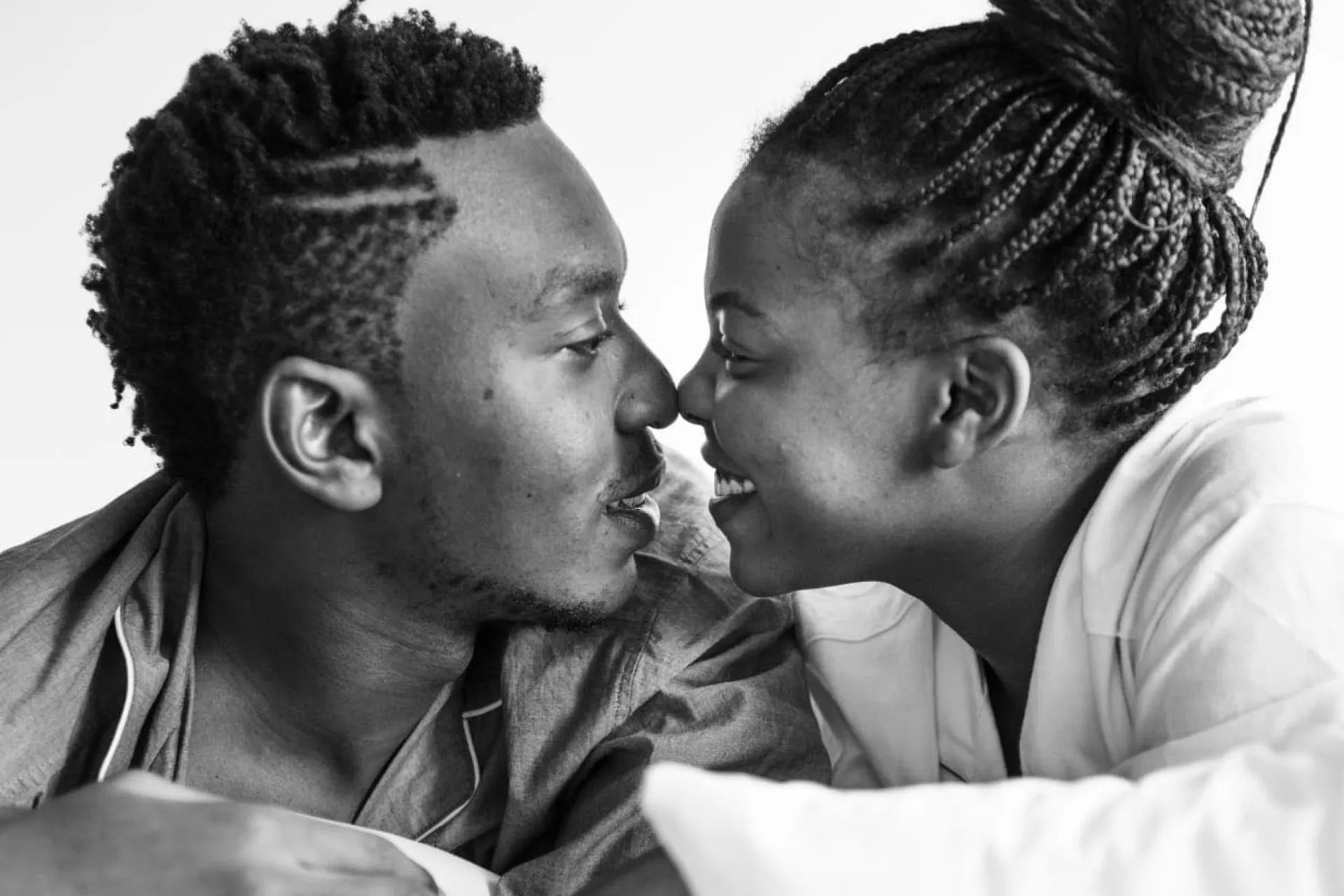 A man and a woman touching noses and smiling