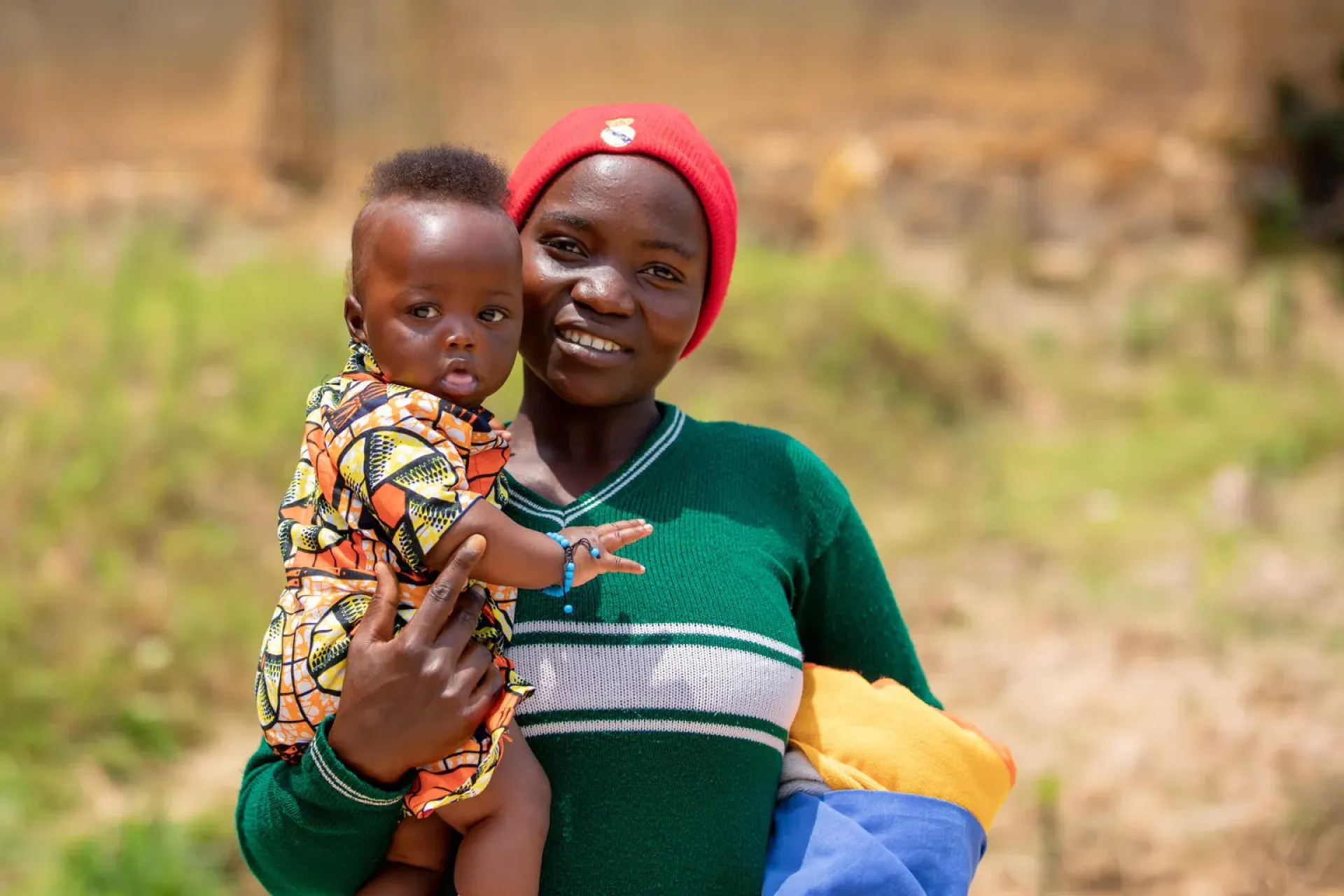 Clarisse Twizeremana, 22, holds her baby girl Julienne, 5 months, outside a community centre in Nemba, Gakenke District, Rwanda.