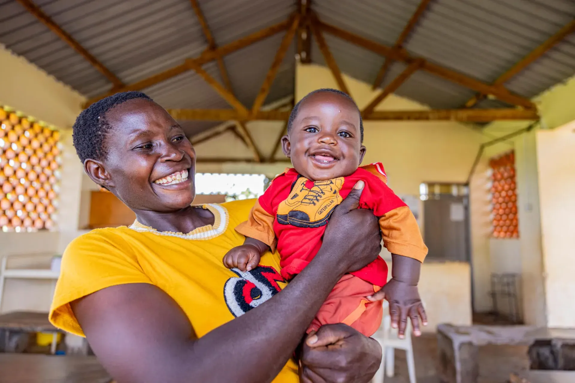 Jackline Nabwire, 24 year old mother with her baby after attending a health talk at Bumooli Health Centre III, Buswale Sub-county, Namayingo District, 6 May 2025.