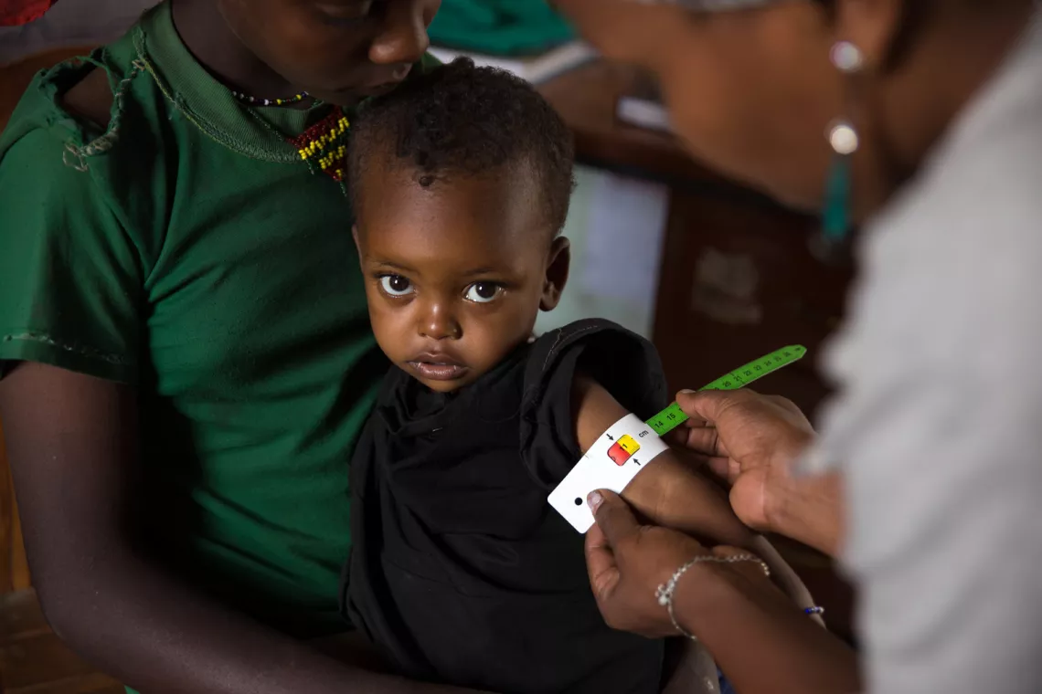 A toddler has her mid-upper-arm circumference measured