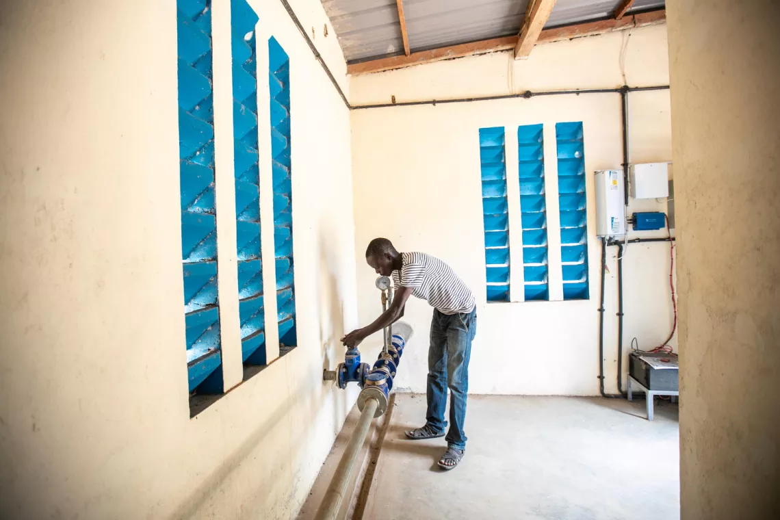 Louse Joseph, a plumber, opens a water and gate valve.