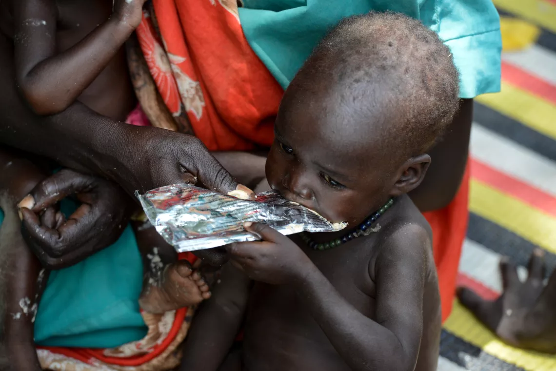 A child receives ready-to-use therapeutic food (RUTF) from a UNICEF-supported Out-Patient Therapeutic (OTP) site near the town of Aweil in South Sudan.