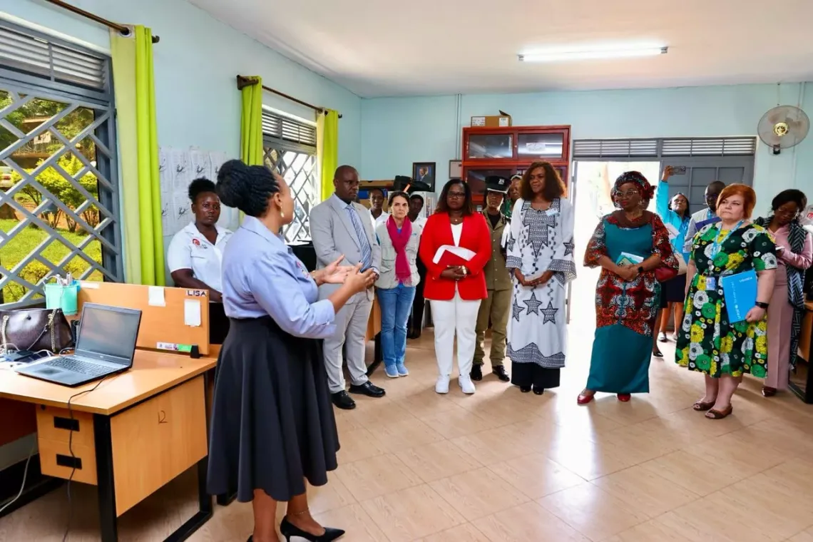 SAUTI 116 staff member demonstrates the child helpline's operations to Minister Balaam (grey suit), UN partners during their tour of the call center in Kireka, April 2025.