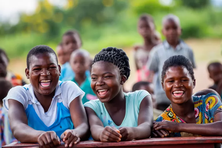 Young teenage girls enjoy a good laugh  during a debate and discussion around some of the challenges youth in Malawi are facing.