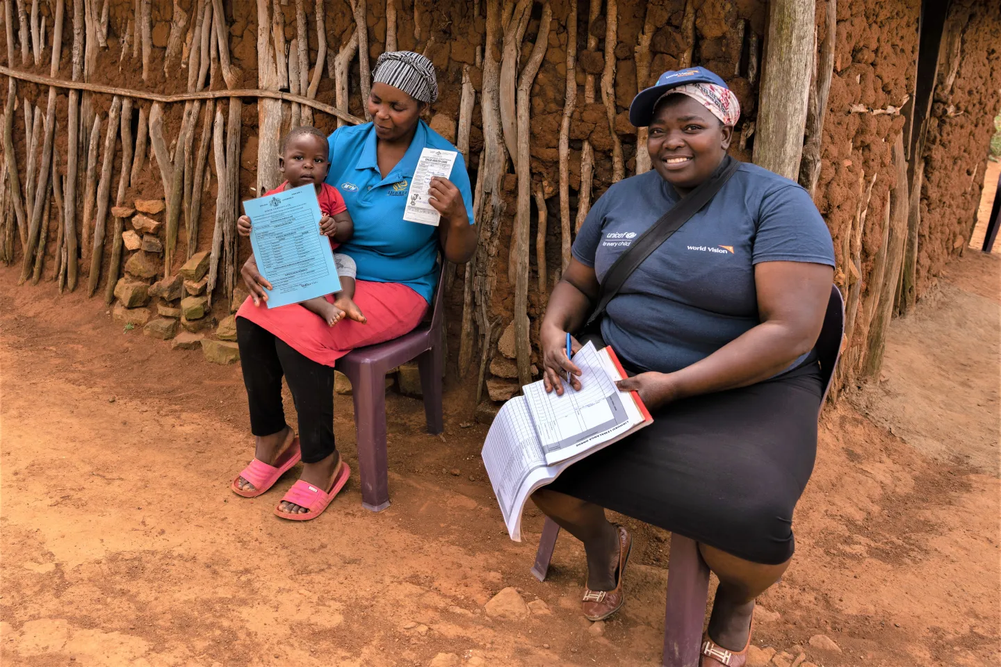 A community health worker during a session with a mother. 