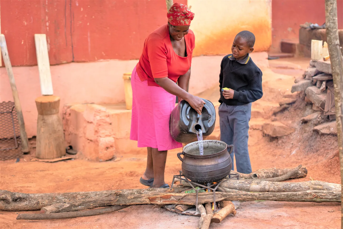 A young boy and his grandmother preparing supper.