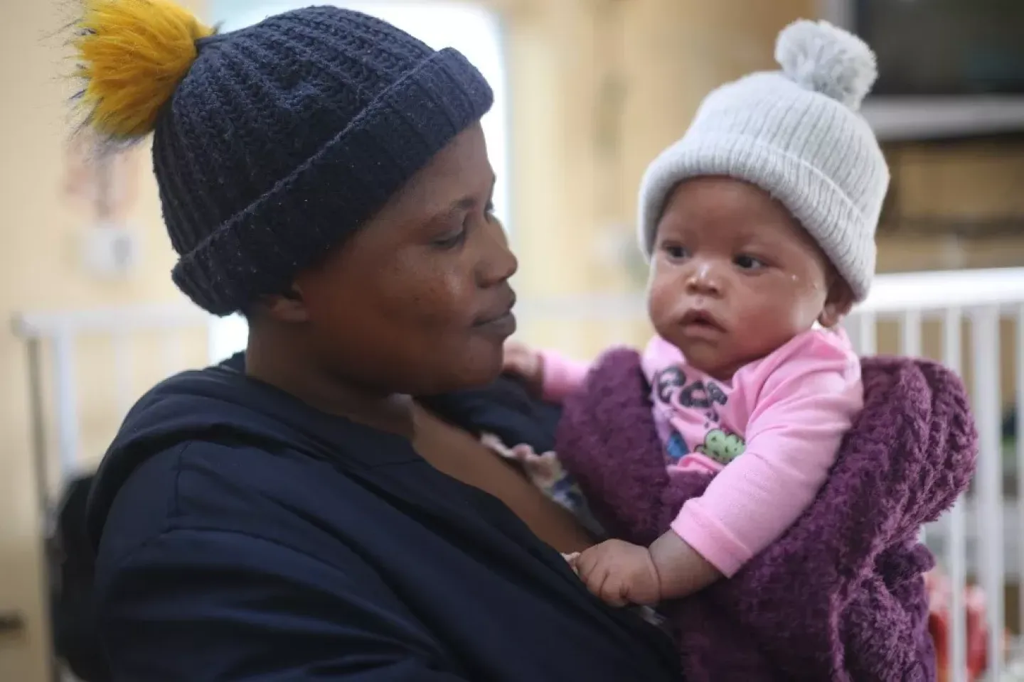 A mother holding her baby inside a maternity ward. 
