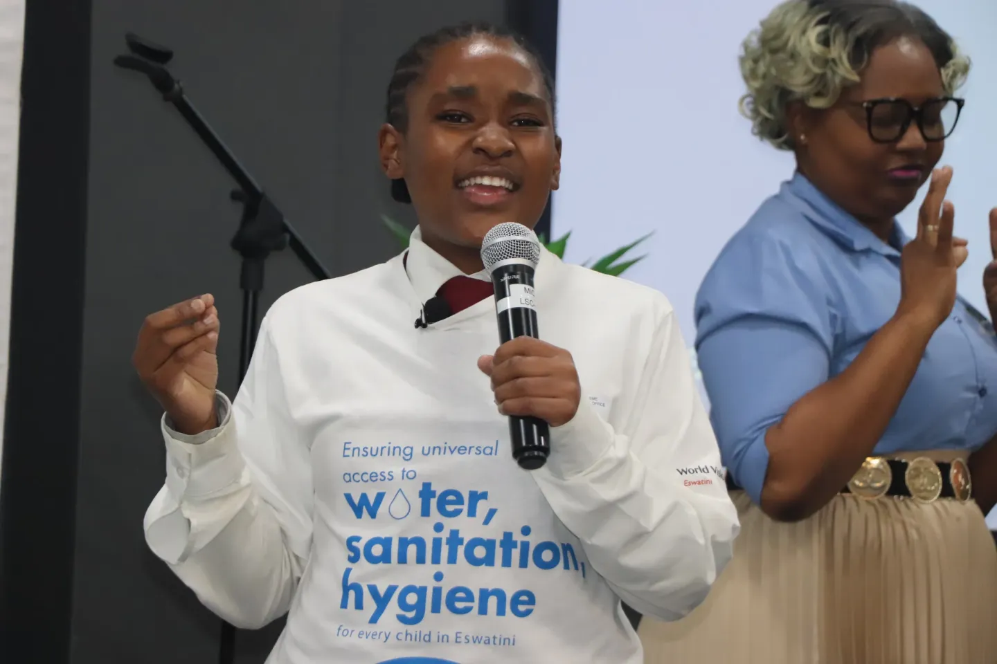a young girl speaking into a microphone