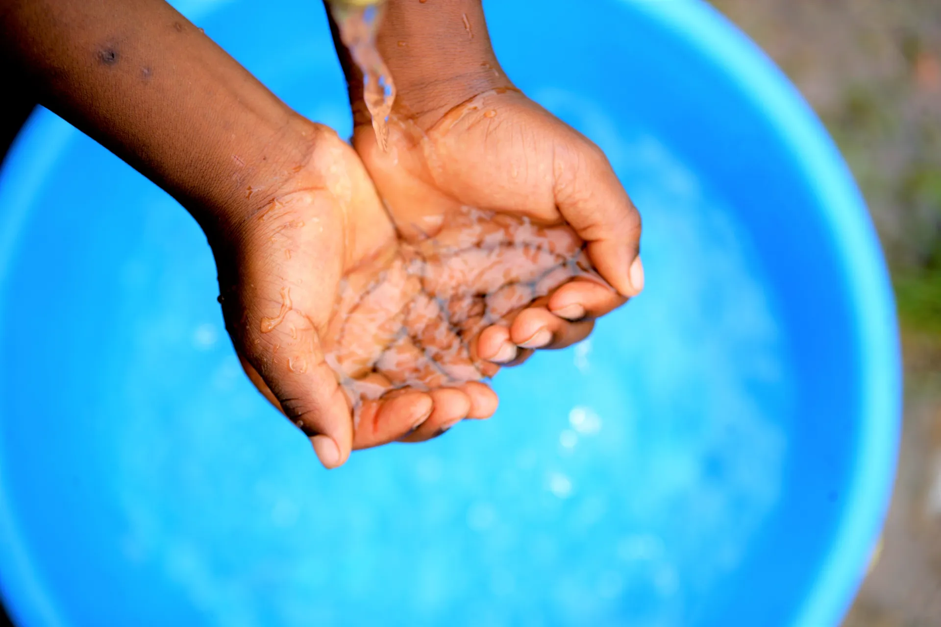 A learner washing hands in school.