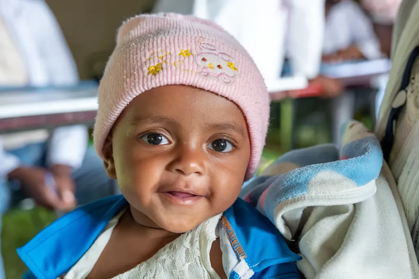 A baby smiling at the camera