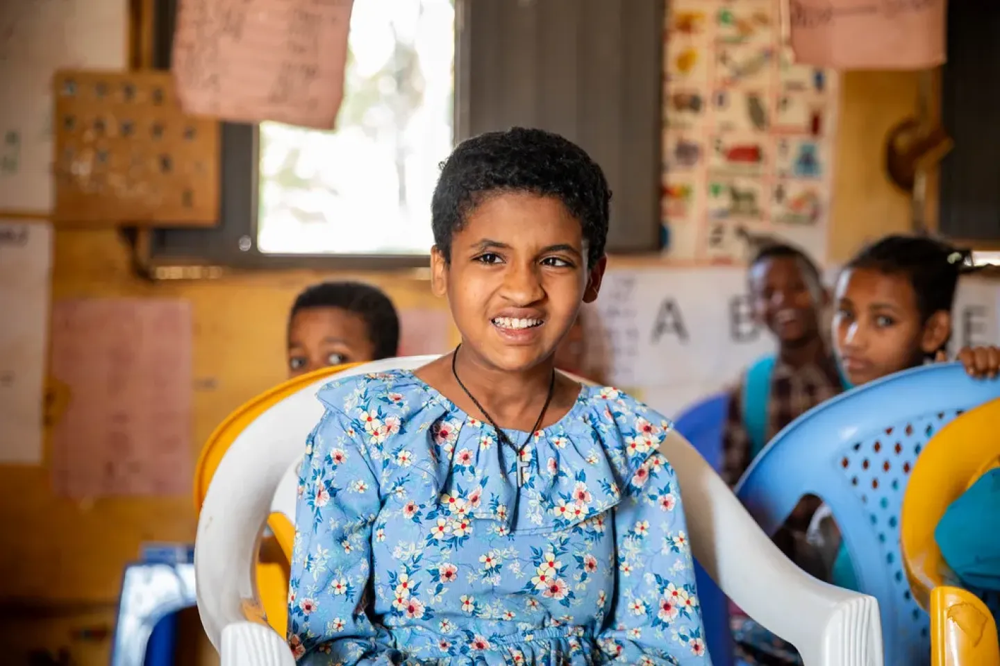 Little girl sitting in her classroom 