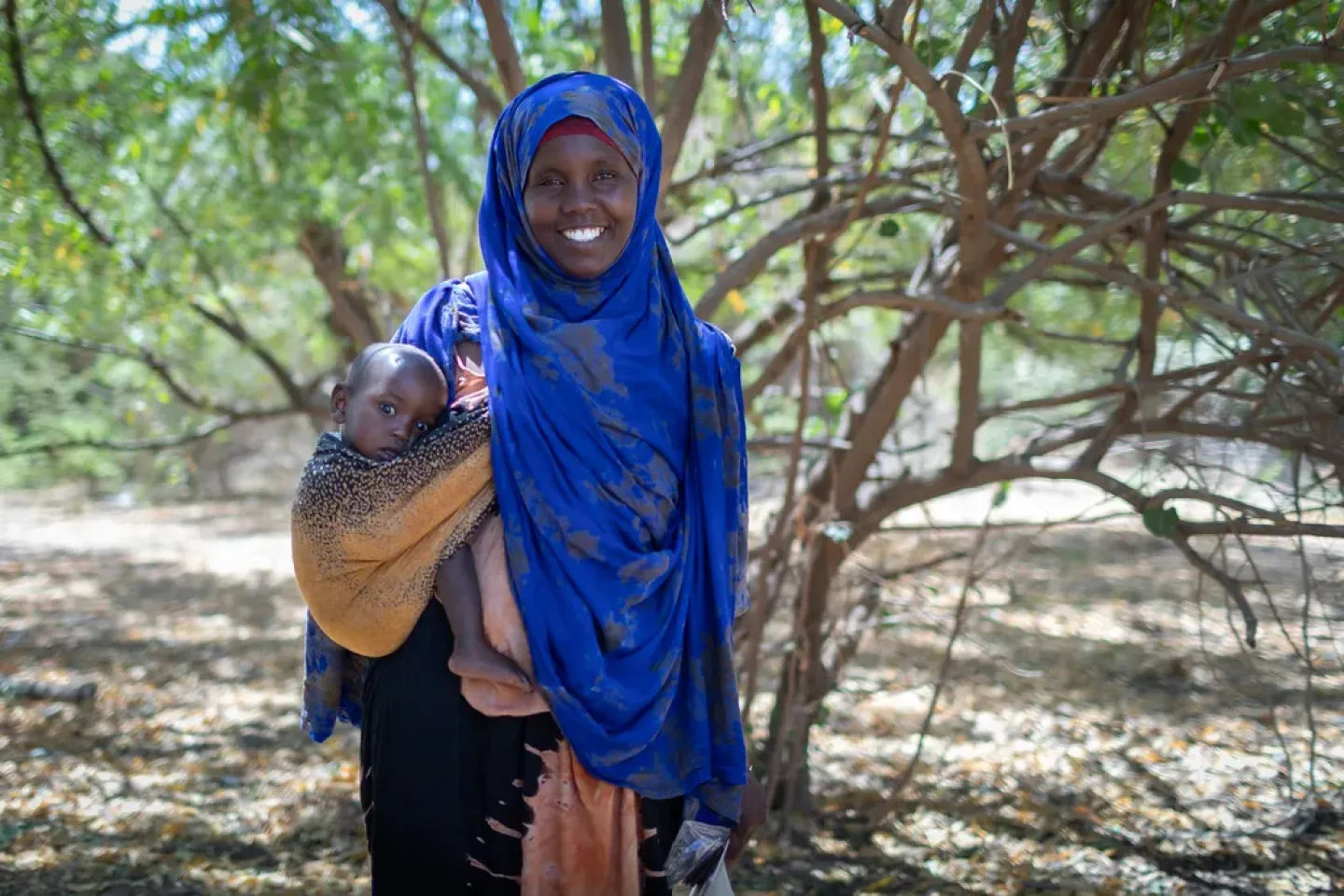 A mother holding her child in her hand 
