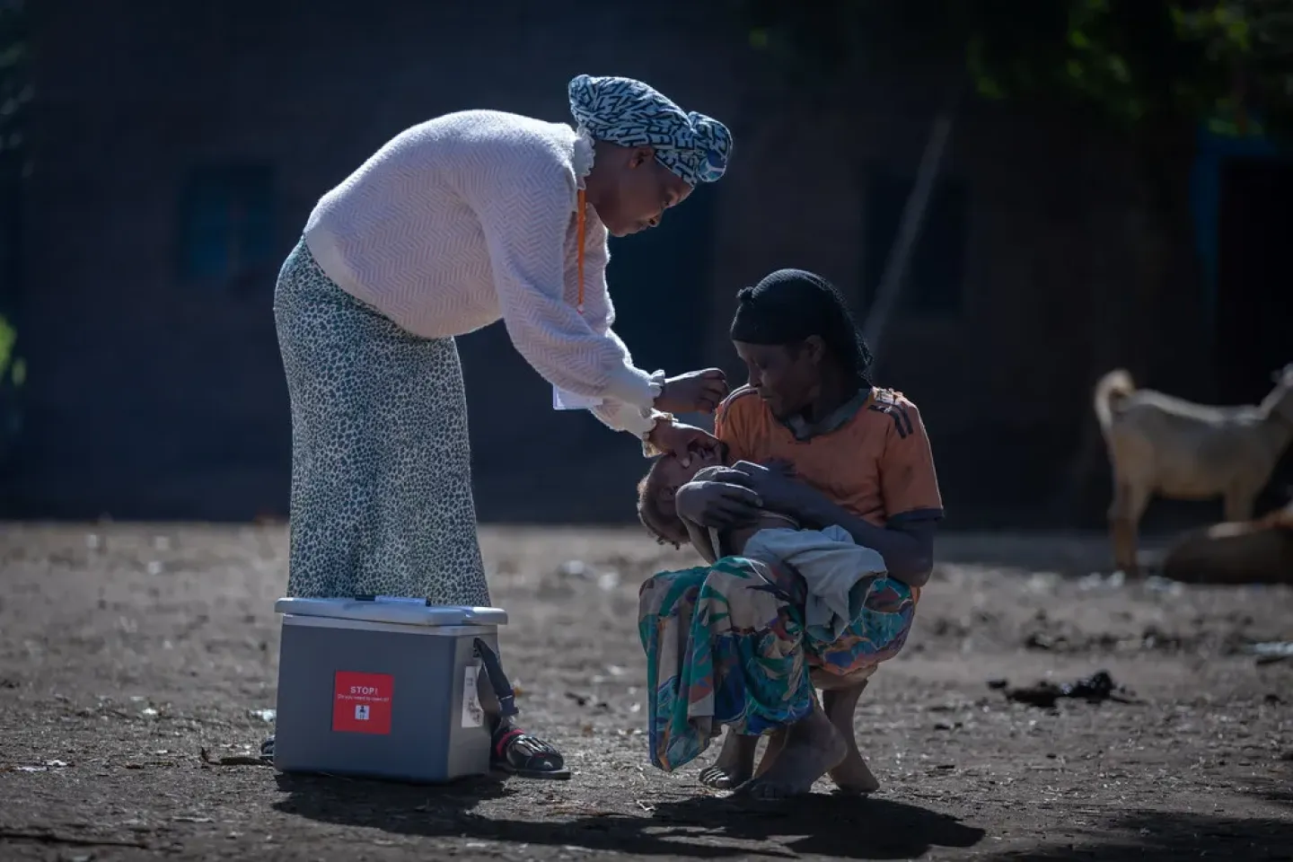 A health worker giving to a child 