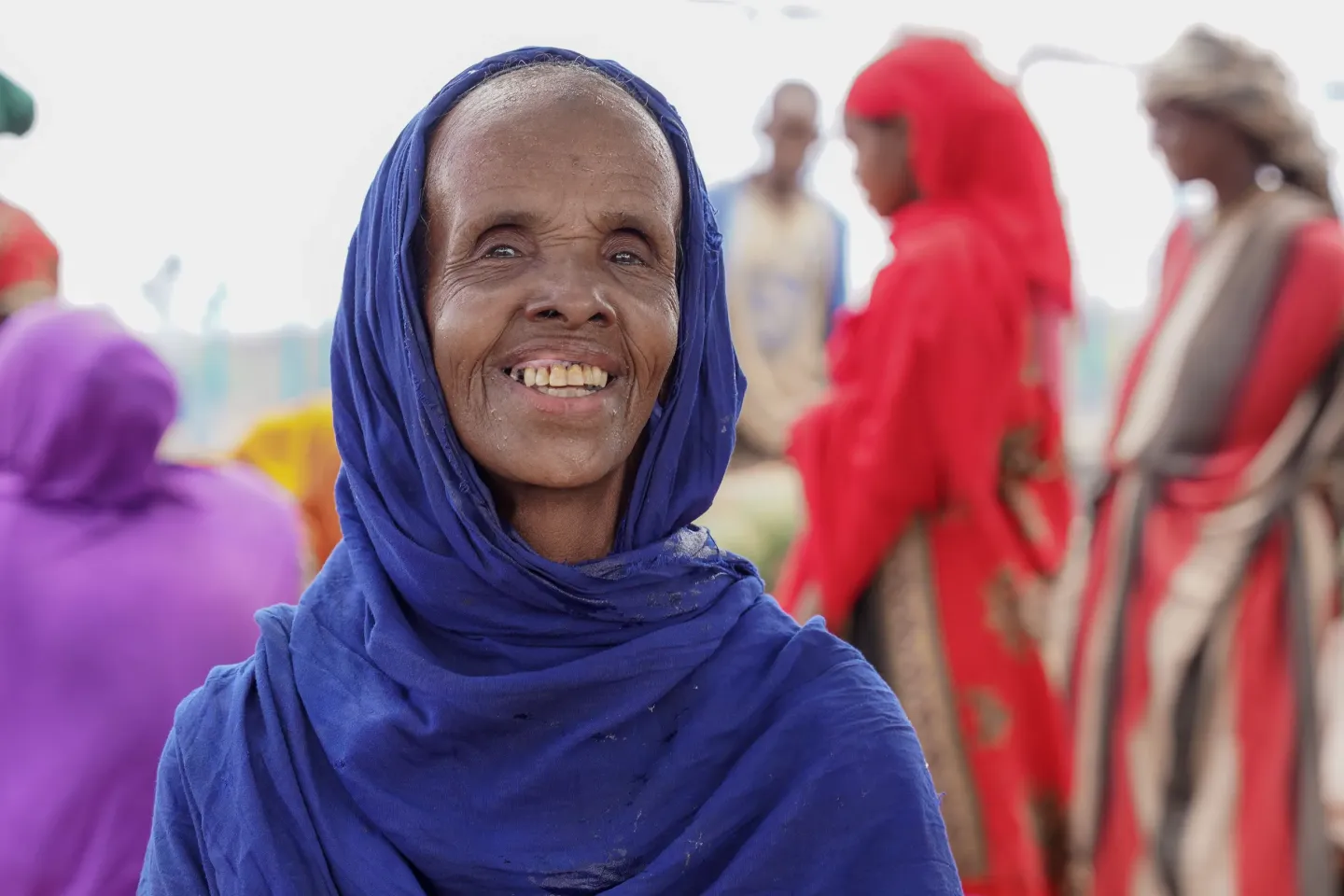 A women sitting Infront of a water point