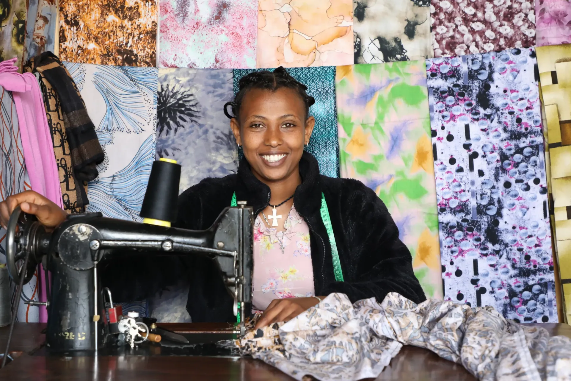 Tizibit Degefe in her sowing workshop/store in Debre Berhan using her sowing machine 