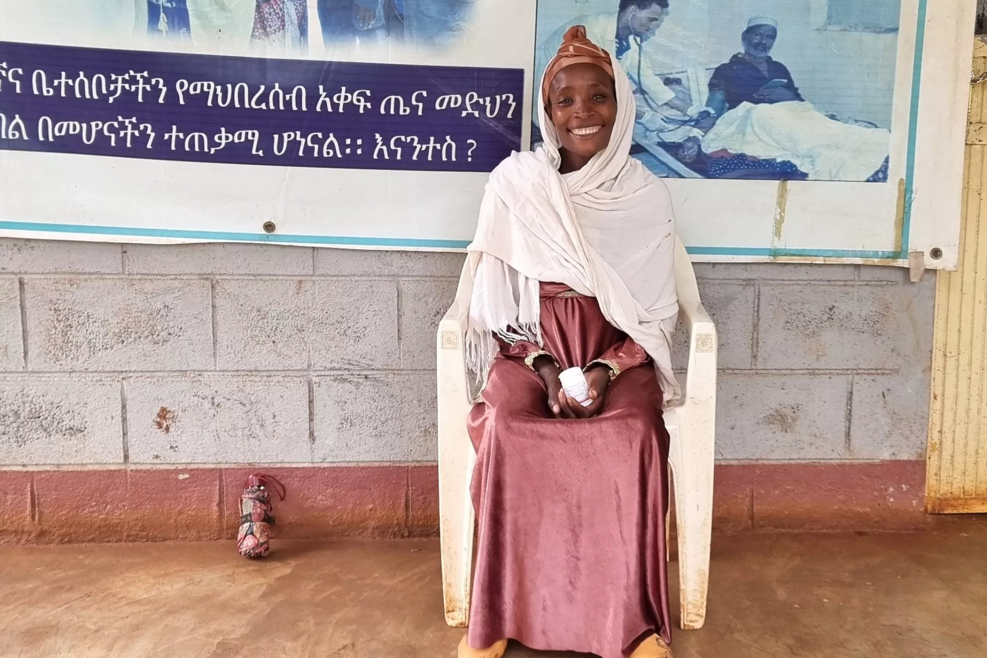 Pregnant woman sitting on a bench at health center. 