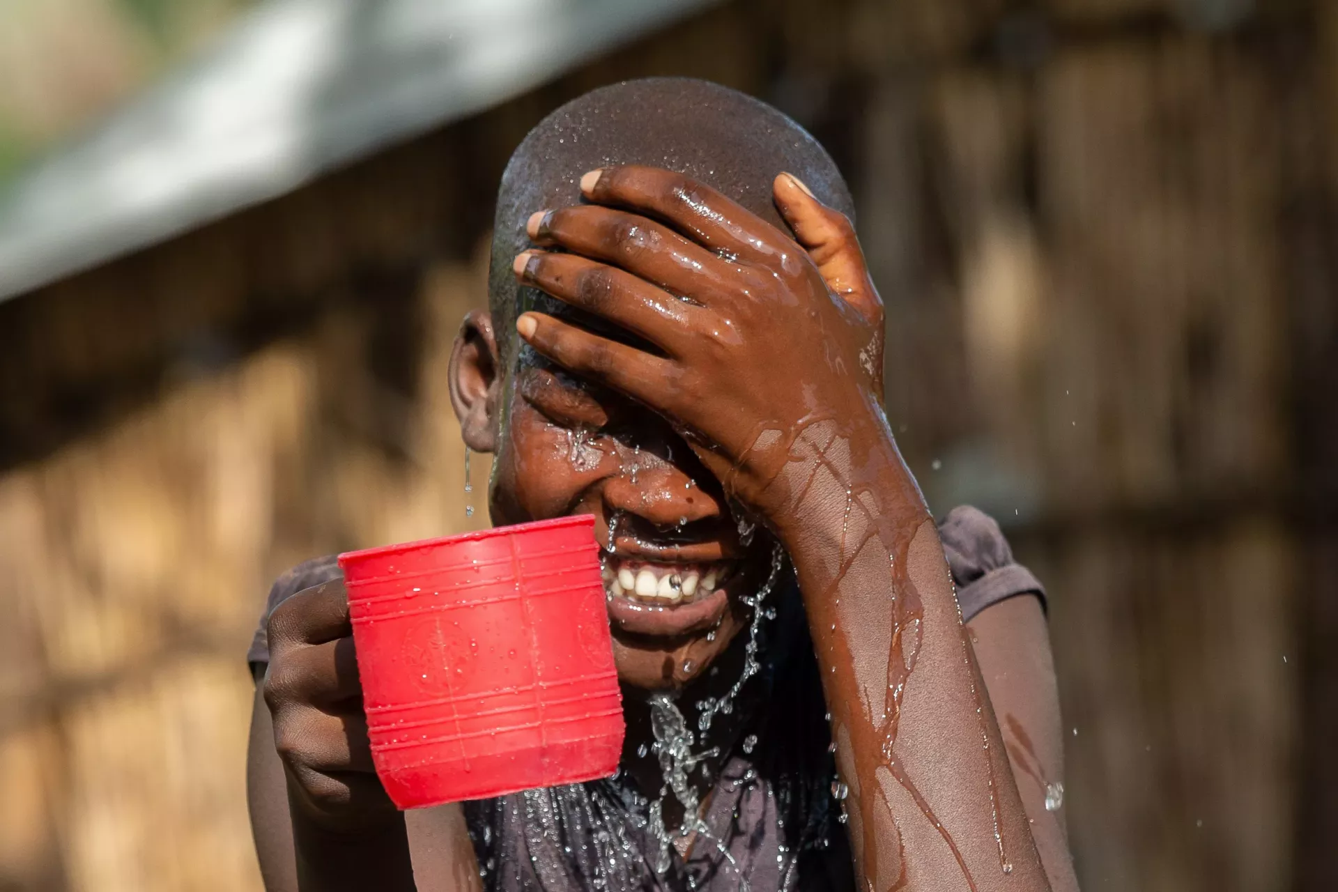 A young girl washing her face 