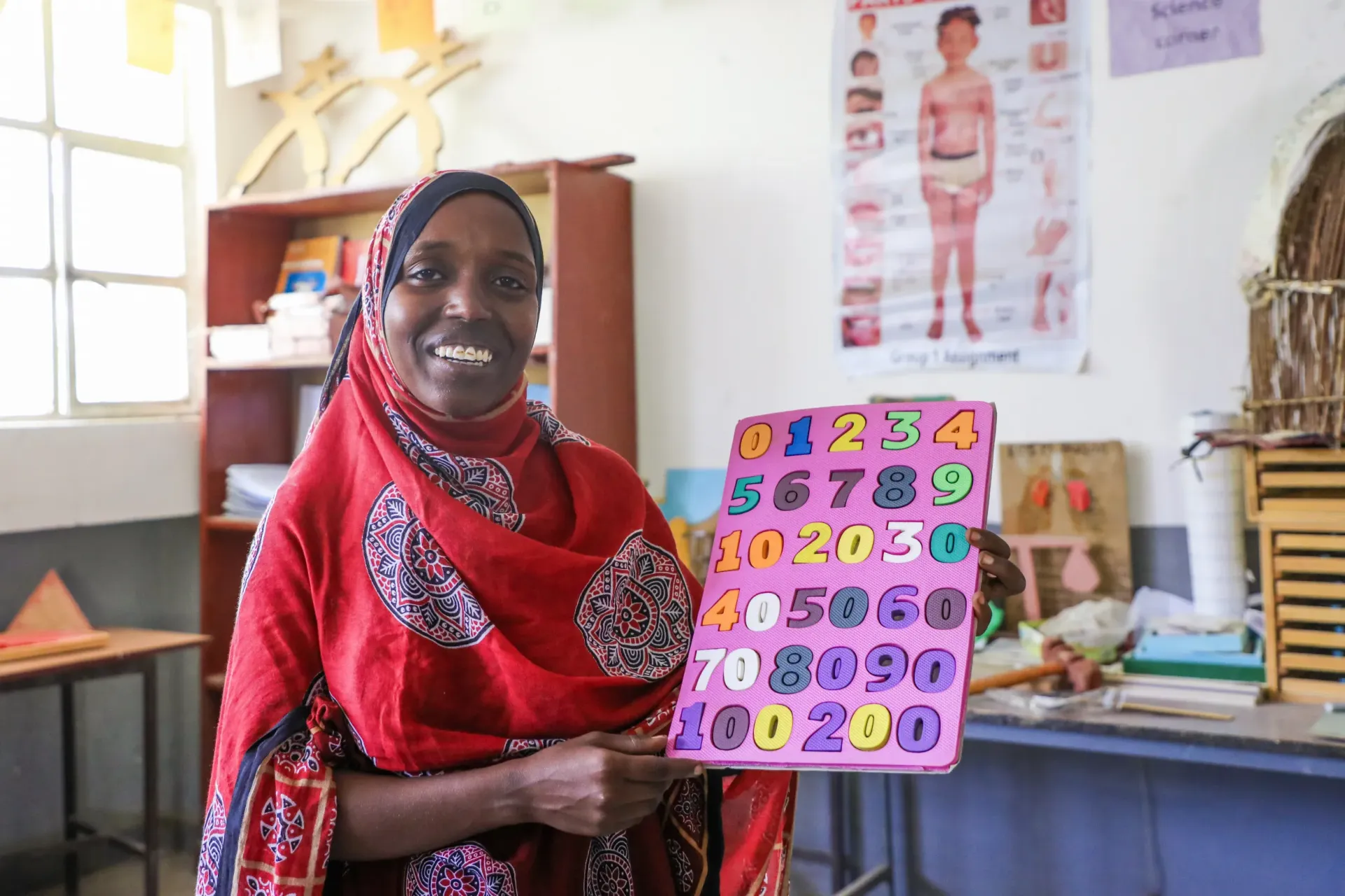 Fetuma Dawud, 22, an ECDE student demonstrating an early childhood educational tool.webp