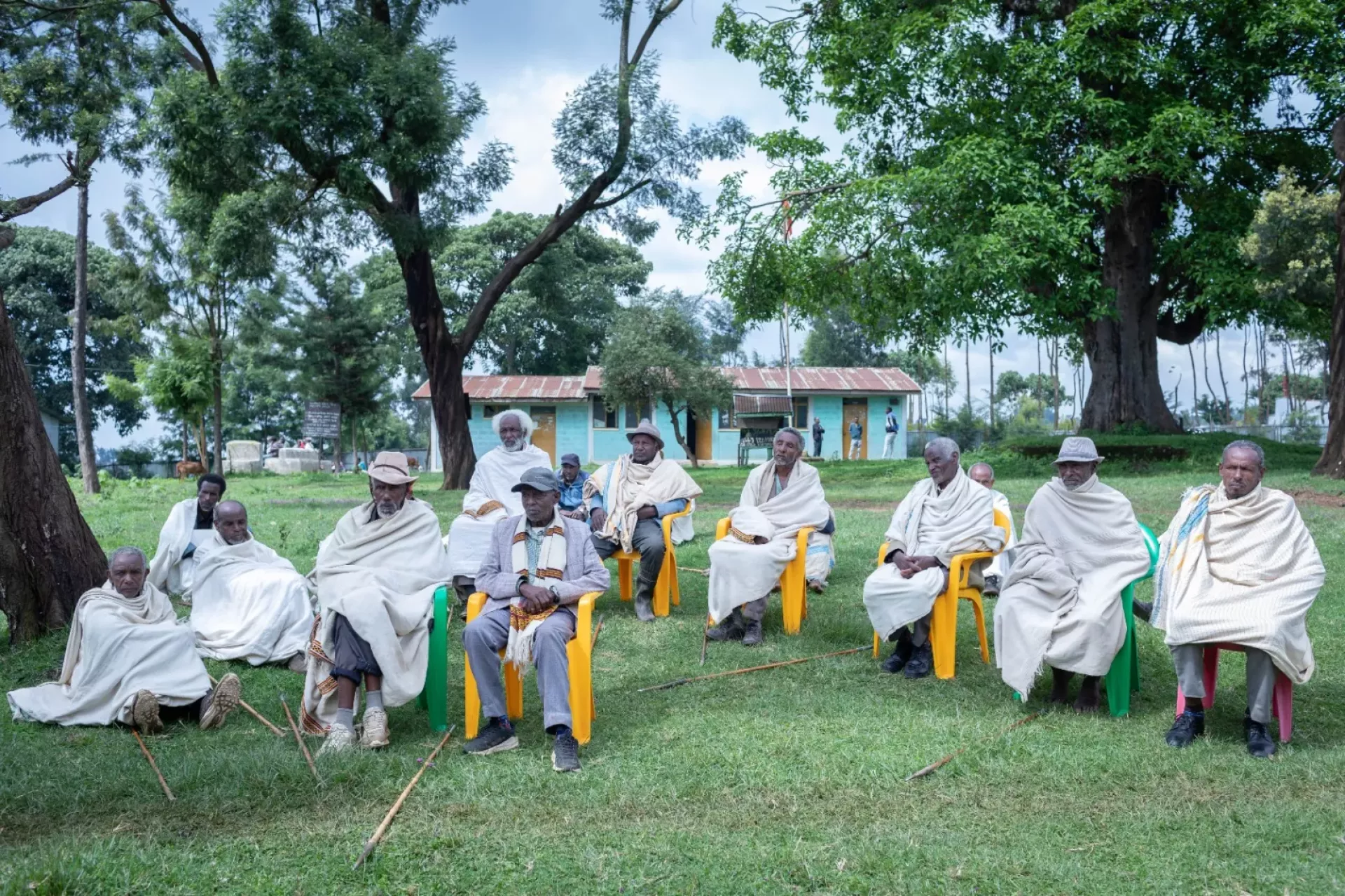 Community elders sitting outside and holding a meeting