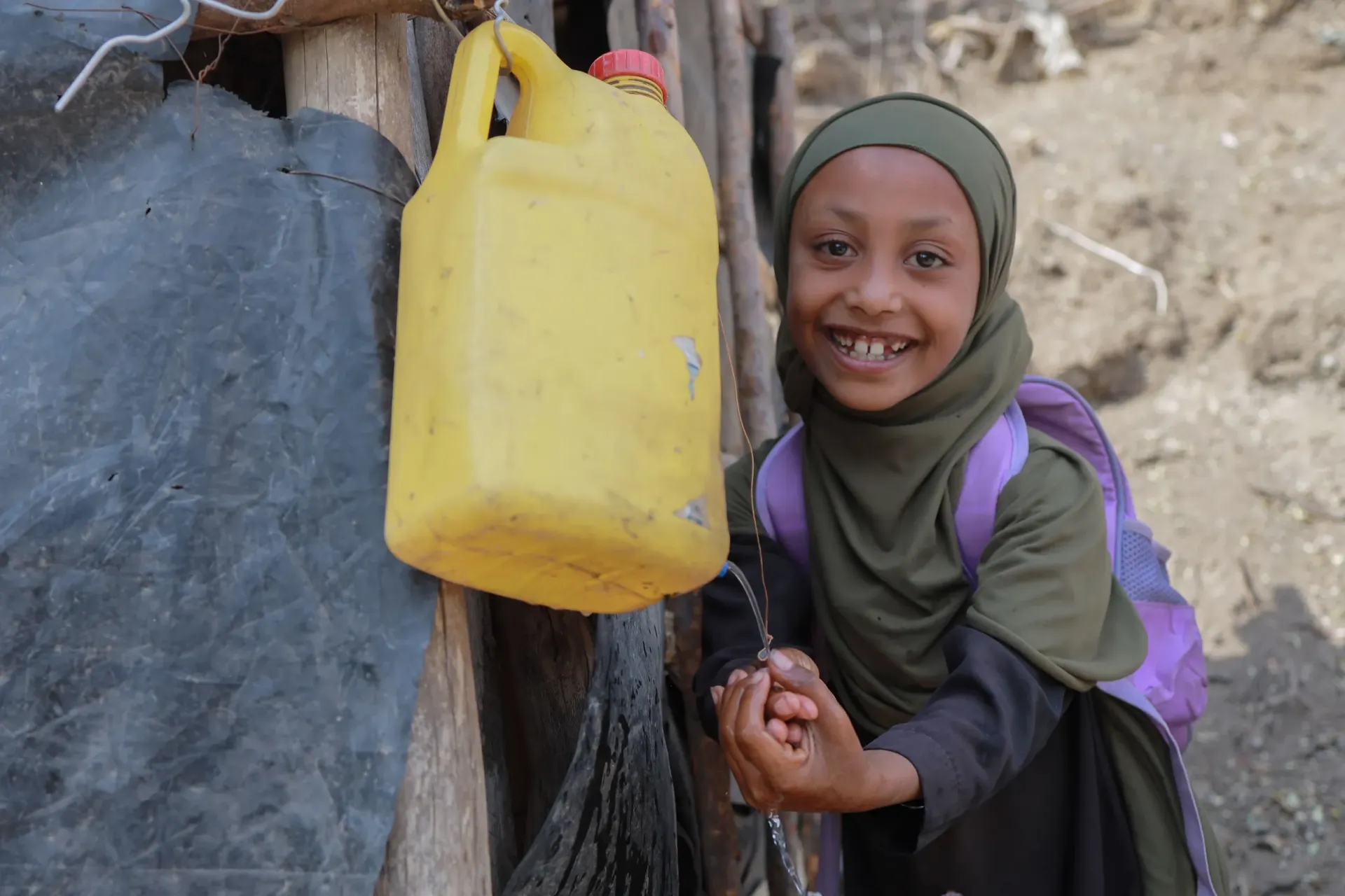 A little girl washing her hand