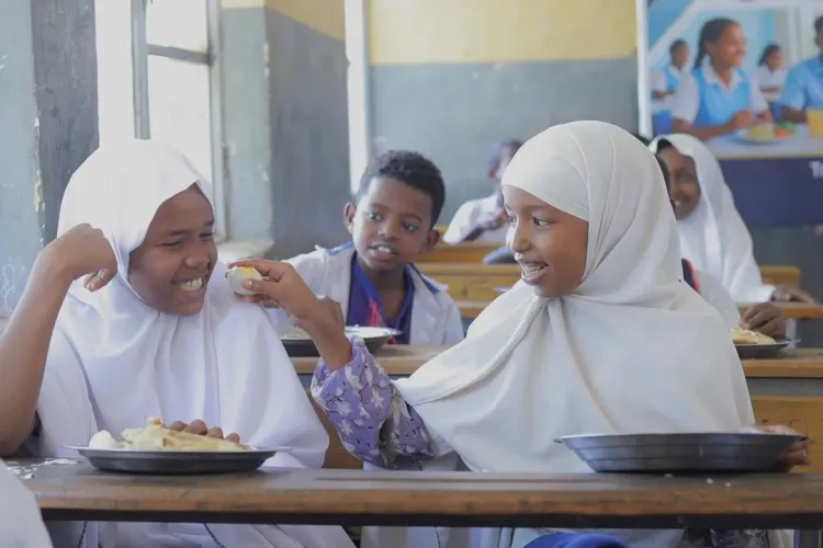 Two young female students enjoying their school mean that incudes egg