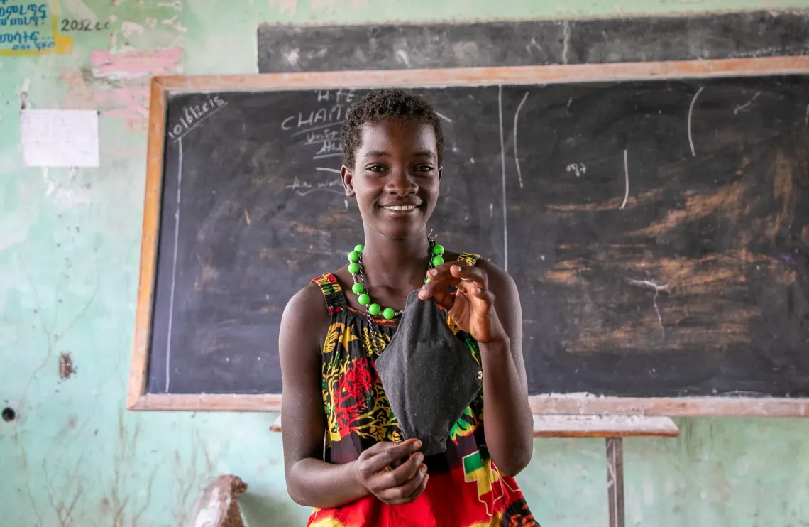 Haksa holding a reusable menstrual pad