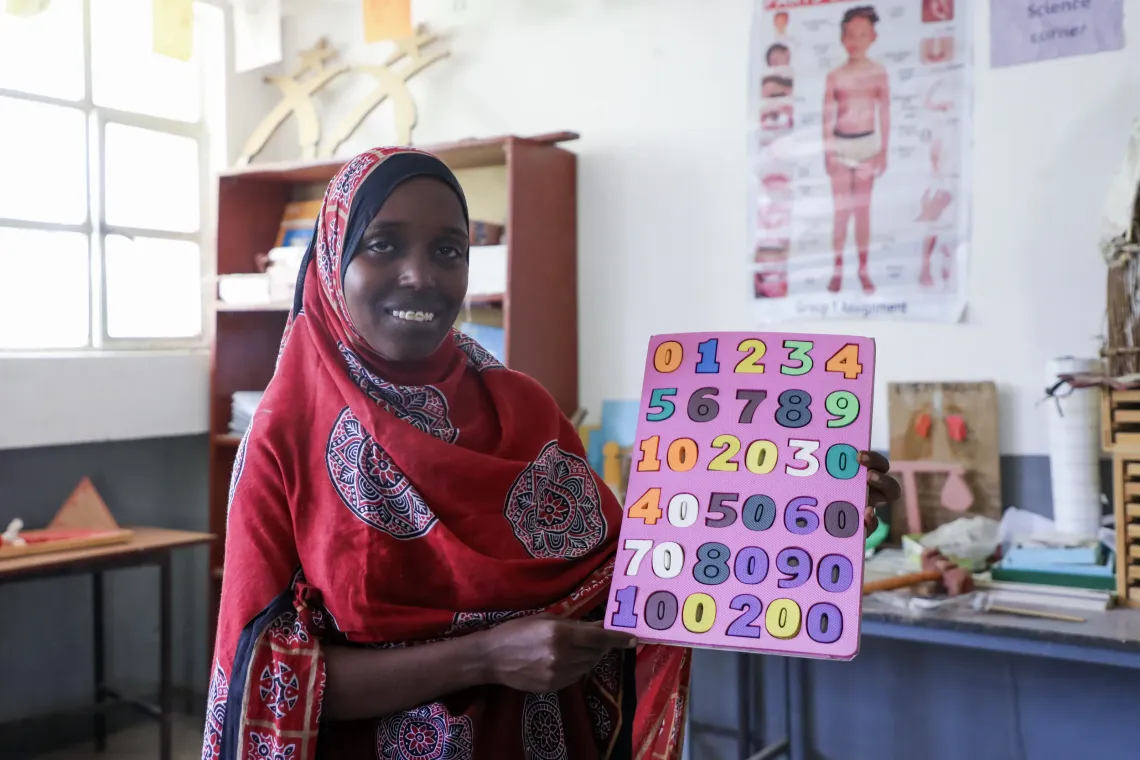 Fetuma Dawud, 22, an ECDE student demonstrating an early childhood educational tool.webp