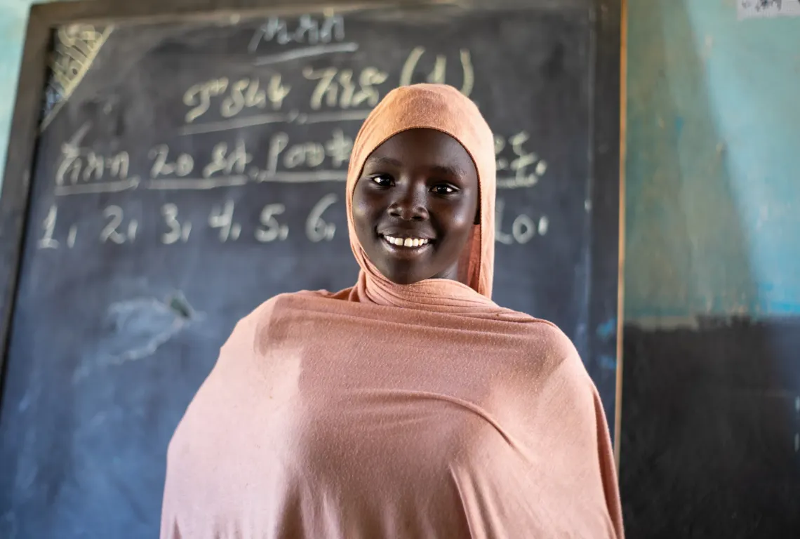Rawiya Hamid standing in her classroom