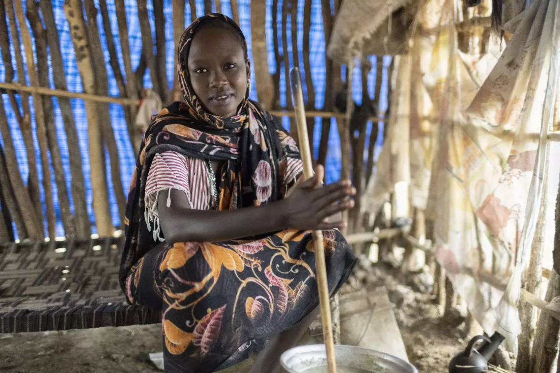 A young girl cooking a meal in her kitchen 