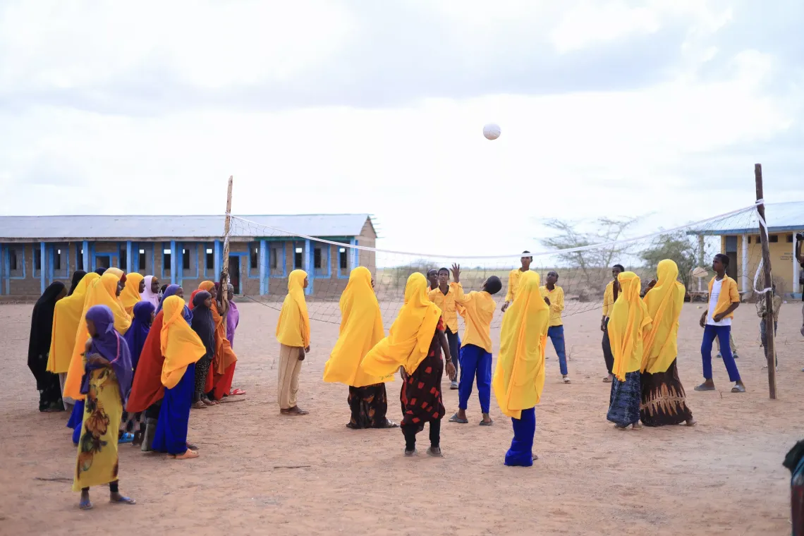 Secondary school children playing volleyball in their SPEED school