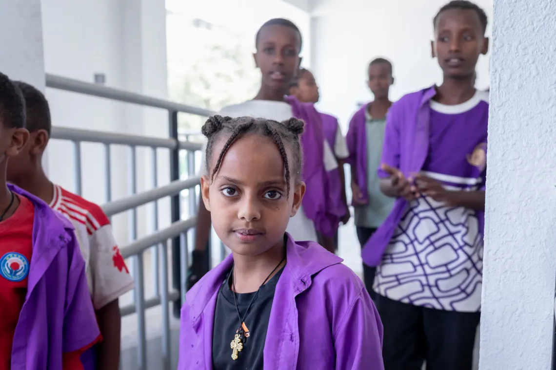 10‑year‑old Nanati Luta standing in her school's hallway