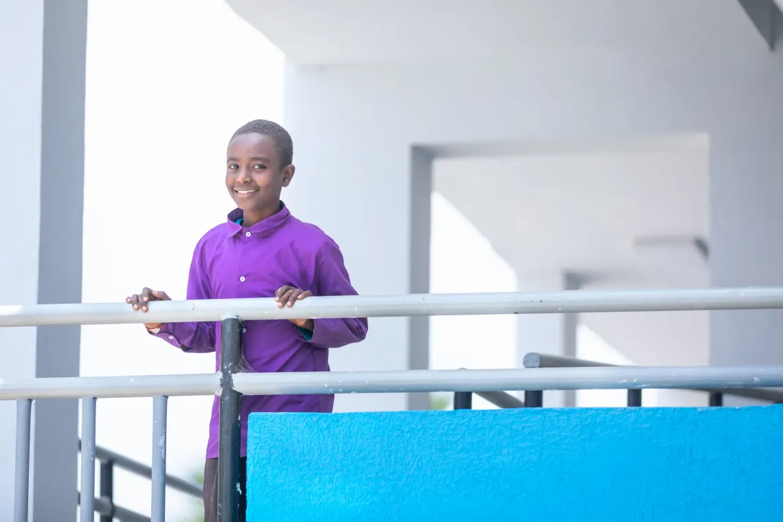    Natnael Temesgen, a 14‑year‑old 7th graders standing against a school balcony railing