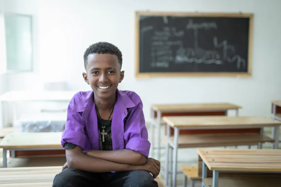 Yeabsira Getu, a 15‑year‑old 7th grader, sitting in his classroom