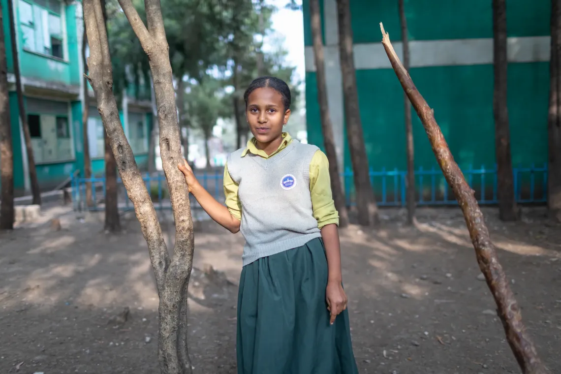  young female student looking straight and posing for the camera