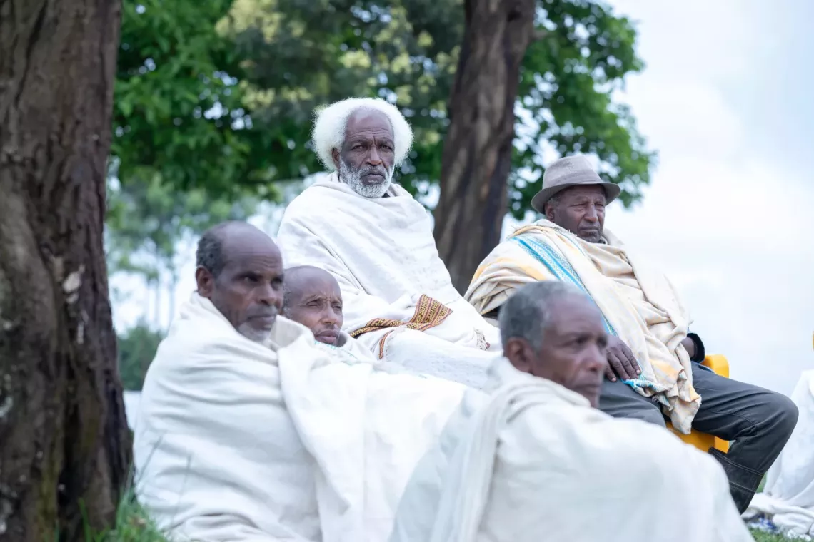 Community elders conducting a meeting outside