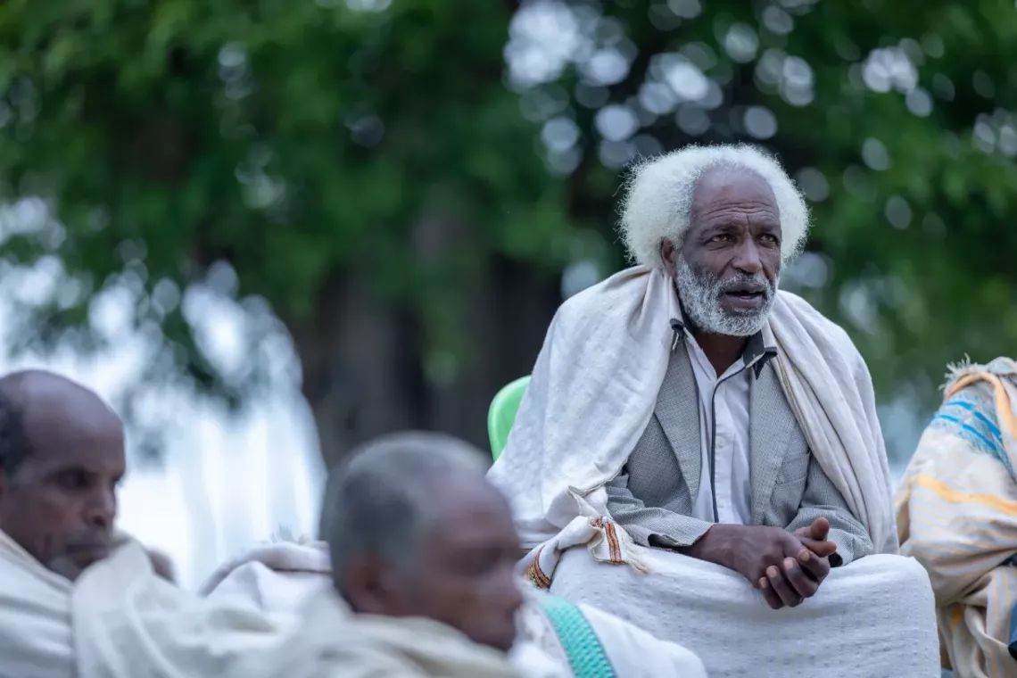 Community elders conducting a meeting outside