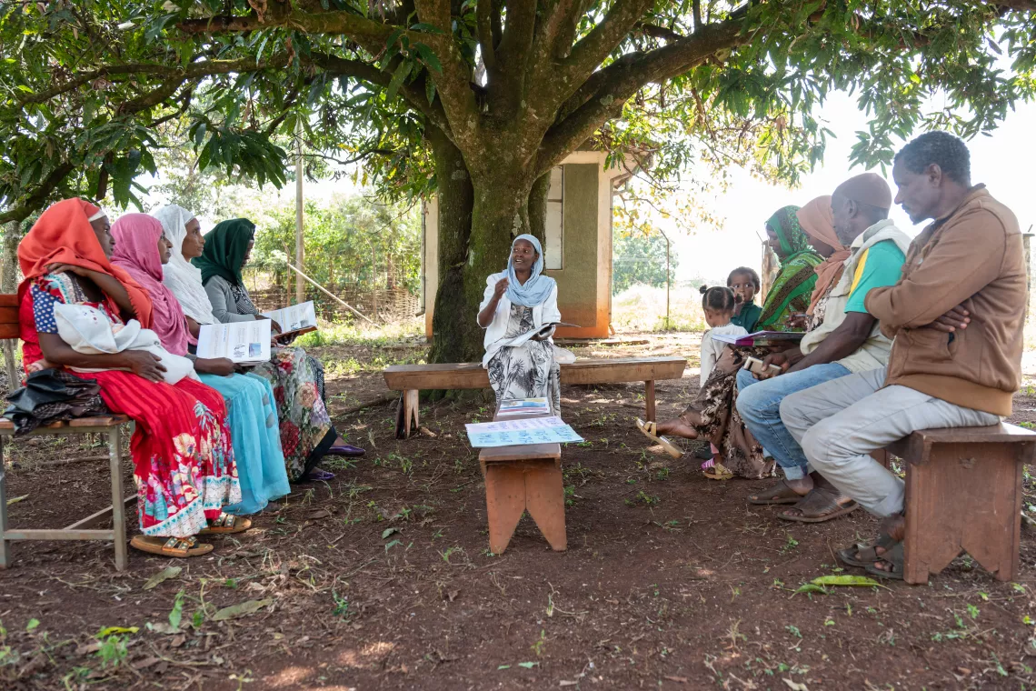 A health worker explaining how they register pregnant mothers and newborn babies while showing the voucher to the camera